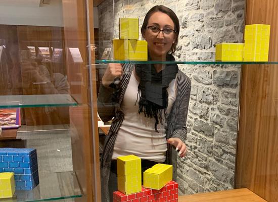 Lady putting blocks in a display
